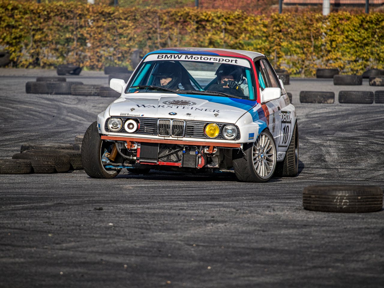BMW motorsport vehicle speeding around a track with skillful handling in a race setting.