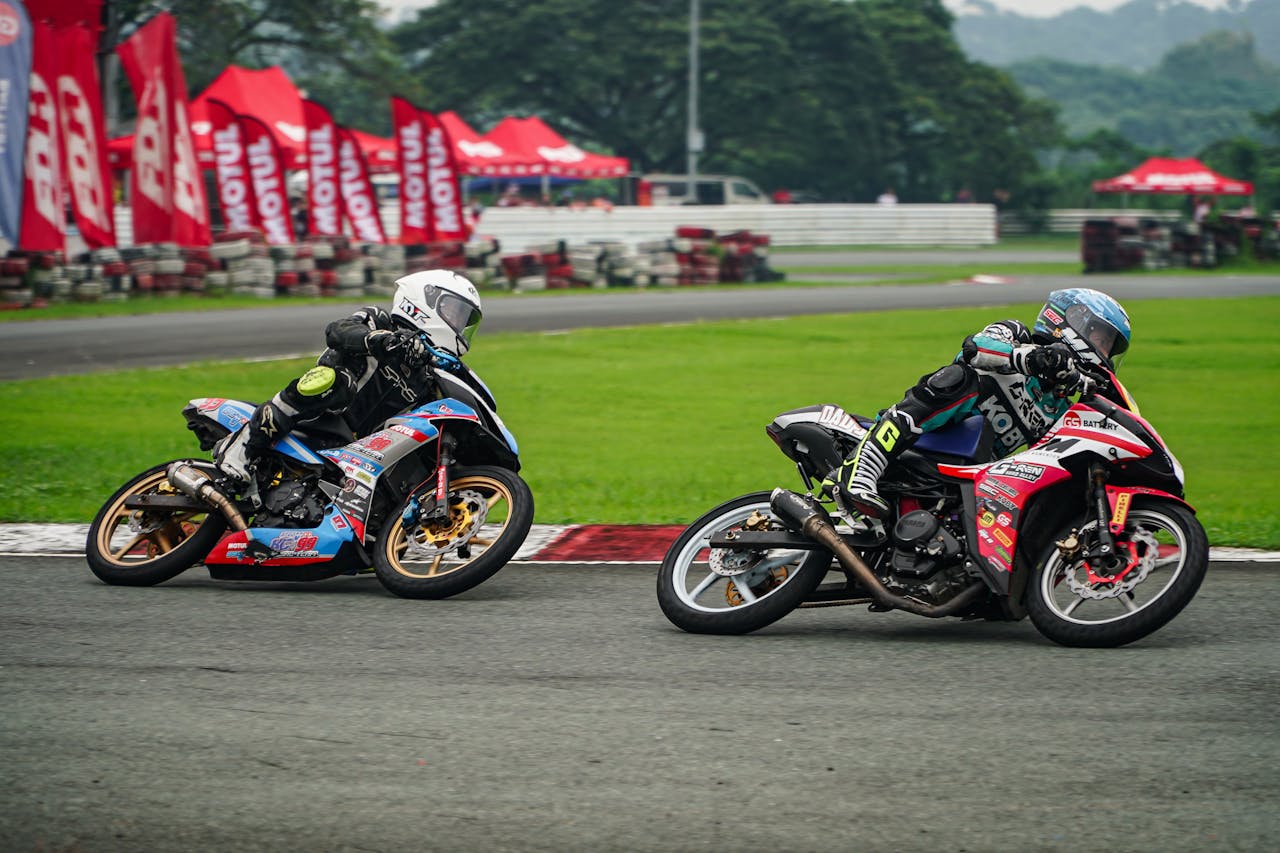 Two motorcyclists race on a track in Tarlac City, showcasing speed and skill.