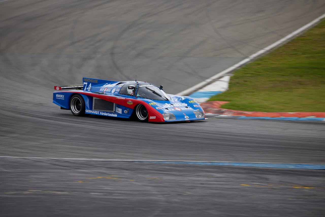 A vibrant race car speeds along the Hockenheimring in Germany, showcasing motorsport thrill.